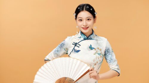 Elegant Woman in Traditional Chinese Qipao with Hand Fan Desktop Wallpaper