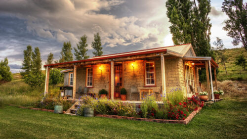 Rustic Stone Cabin Retreat Surrounded by Summer Flowers 4K Desktop Wallpaper