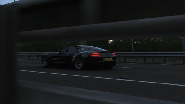 Black Aston Martin One 77 Driving on Highway at Twilight Desktop Wallpaper
