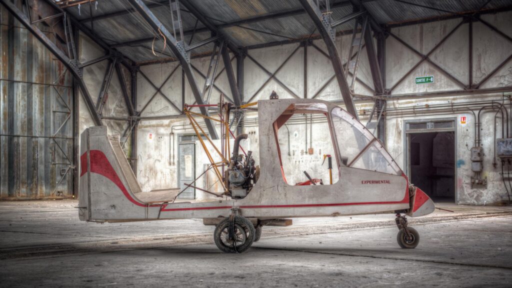 Abandoned Experimental Aircraft in Industrial Hangar Desktop Wallpaper