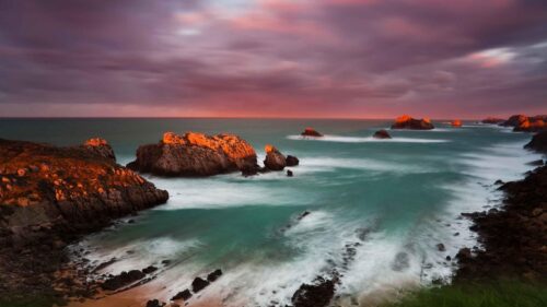 Stunning Coastal Sunset with Dramatic Golden Cliffs and Ocean Waves 4K Wallpaper