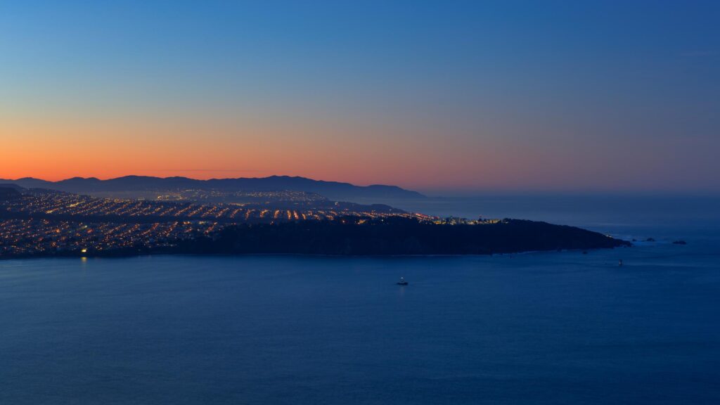 Stunning Coastal Cityscape at Twilight Overlooking the Pacific Ocean 4K Wallpaper