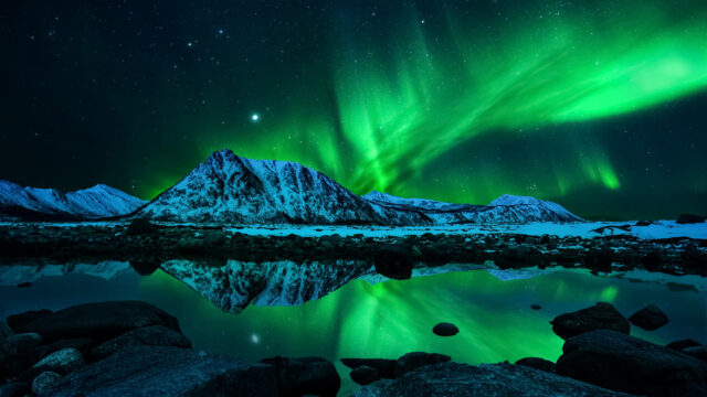 Breathtaking Northern Lights Over Snowy Mountain Desktop Wallpaper