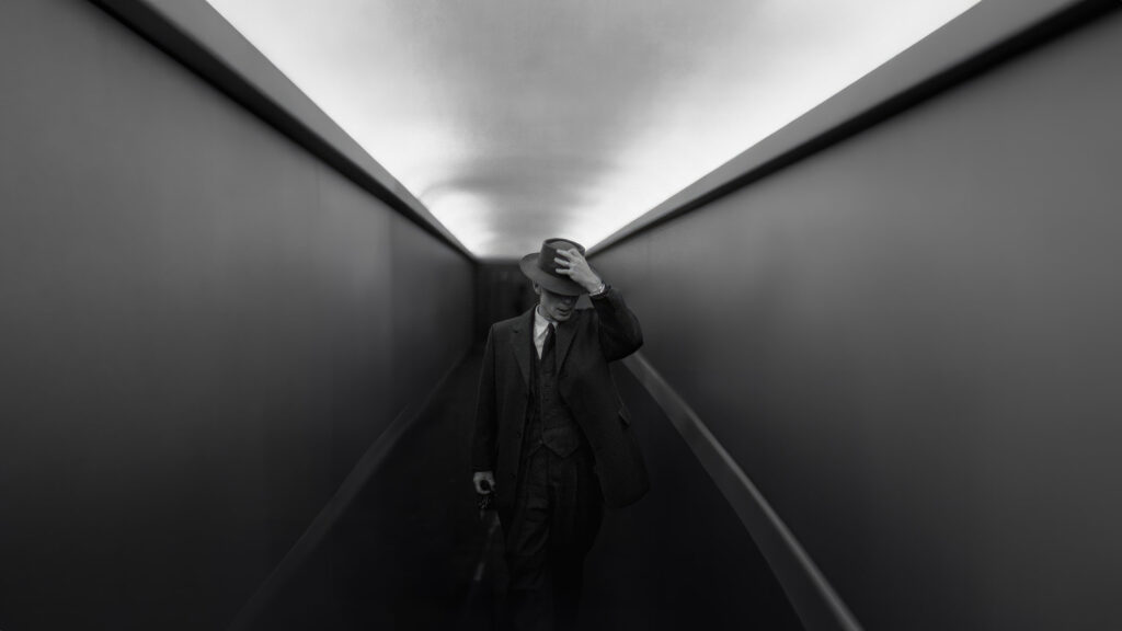 Man in Vintage Suit Walking Through Minimalist Tunnel Desktop Wallpaper