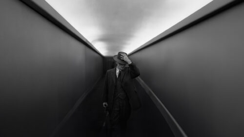 Man in Vintage Suit Walking Through Minimalist Tunnel Desktop Wallpaper