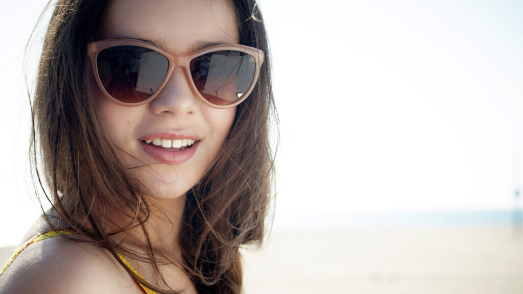 Close-up Portrait of a Smiling Young Woman Desktop Wallpaper