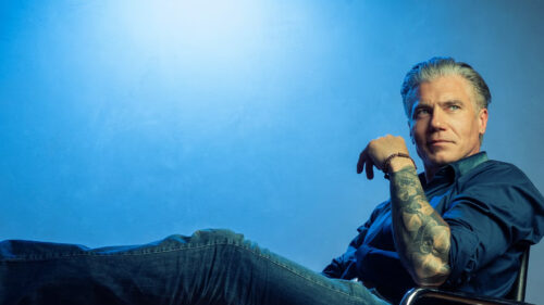 Portrait of a Tattooed Man with Salt and Pepper Hair Desktop Wallpaper