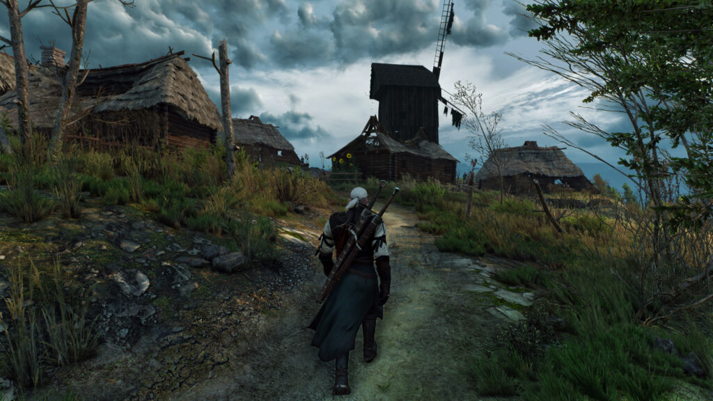 Geralt of Rivia Walking Through a Velen Village Desktop Wallpaper