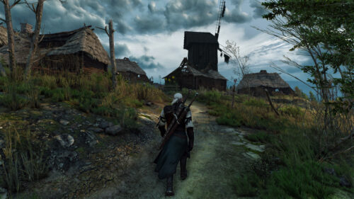 Geralt of Rivia Walking Through a Velen Village Desktop Wallpaper