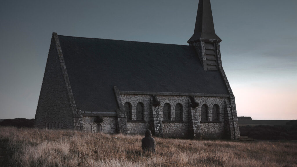 Lone Wanderer at the Stone Chapel Desktop Wallpaper