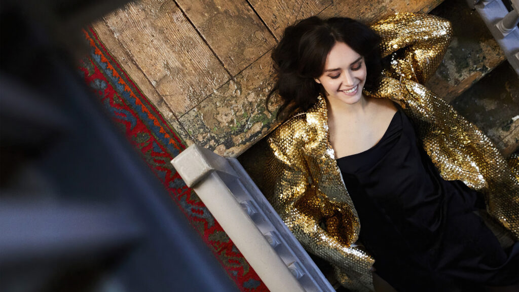 Elegant Woman in Gold Sequin Jacket Desktop Wallpaper