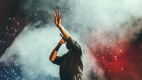 Concert Performer Raising Hand Desktop Wallpaper