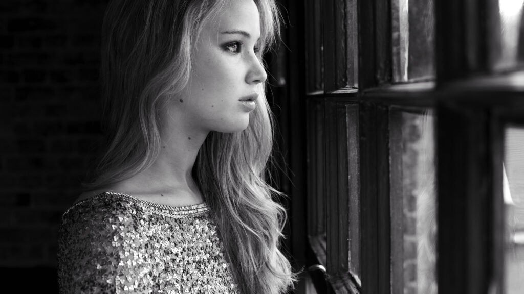 Stunning Portrait of a Woman by a Window Desktop Wallpaper