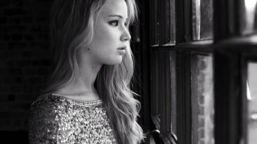 Stunning Portrait of a Woman by a Window Desktop Wallpaper