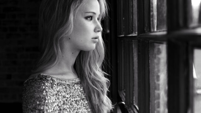 Stunning Portrait of a Woman by a Window Desktop Wallpaper