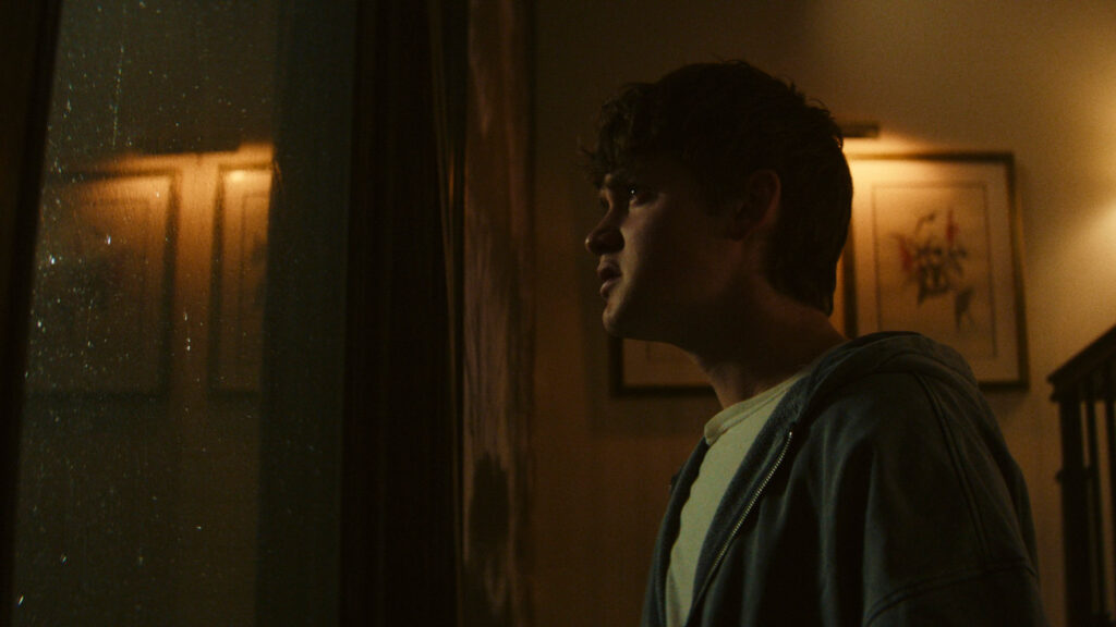 Thoughtful Young Man Looking Out A Window Desktop Wallpaper