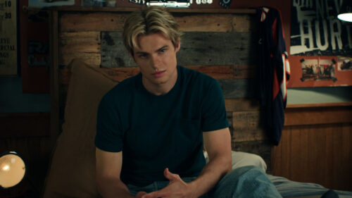 Young Man in Bedroom Setting Desktop Wallpaper