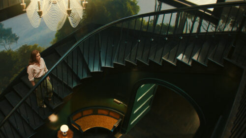 Woman on Staircase Interior 4K Wallpaper