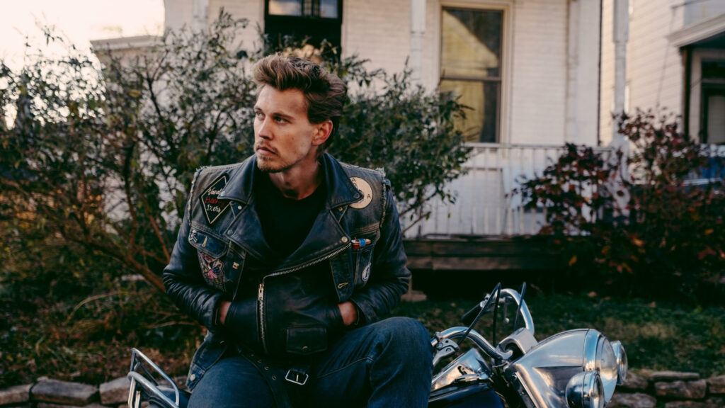 Handsome Man in Leather Jacket Sitting on a Motorcycle Desktop Wallpaper
