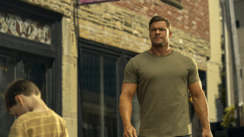Jack Reacher Walking Past Child in City Scene 4K Wallpaper