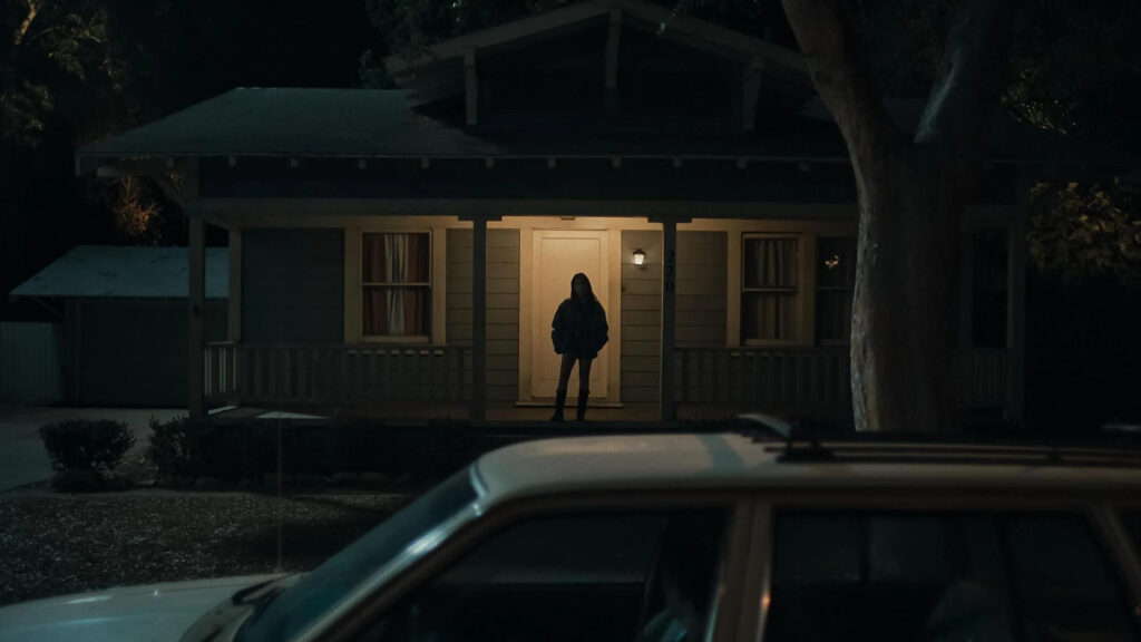 Eerie Silhouetted Figure on a Porch at Night Desktop Wallpaper