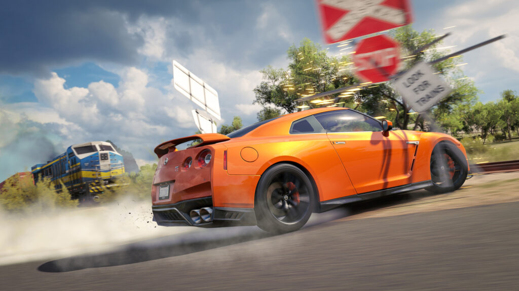 Orange Nissan GT-R Drifting at Railroad Crossing Desktop Wallpaper