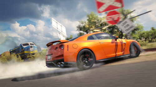 Orange Nissan GT-R Drifting at Railroad Crossing Desktop Wallpaper