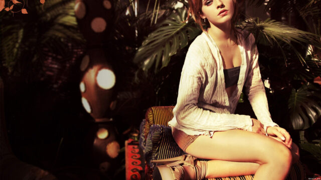 Emma Watson Relaxing in Lush Greenery Desktop Wallpaper