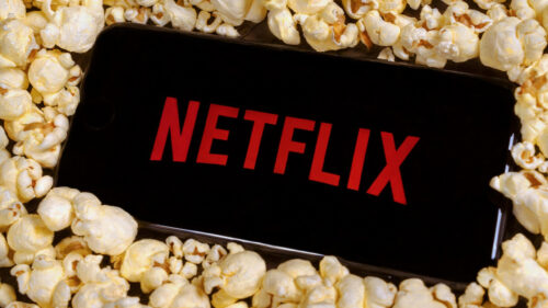 Netflix Logo on Smartphone Screen with Popcorn Desktop Wallpaper