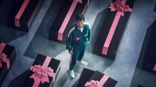 Squid Game Character Among Gift-Wrapped Coffins 4K Wallpaper