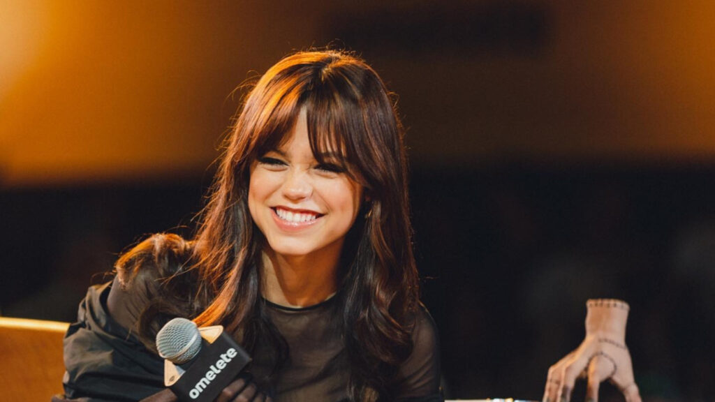 Jenna Ortega Smiling with Thing Hand Desktop Wallpaper