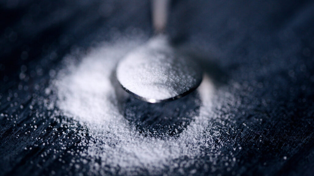 Extreme Close Up White Salt Granules on a Dark Surface Desktop Wallpaper