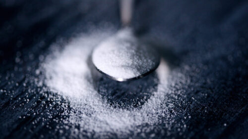 Extreme Close Up White Salt Granules on a Dark Surface Desktop Wallpaper
