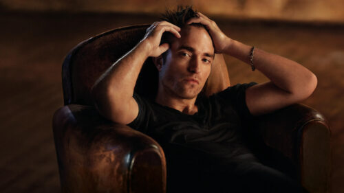 Robert Pattinson Sitting in Leather Chair 4K Wallpaper