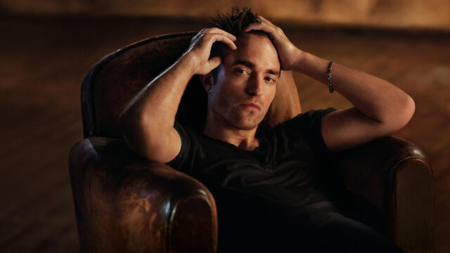 Robert Pattinson Sitting in Leather Chair 4K Wallpaper