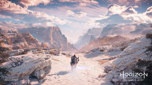 Aloy Riding Through Snowy Mountains Horizon Forbidden West Desktop Wallpaper