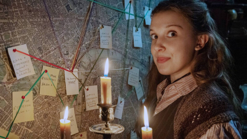 Enola Holmes Investigating a Map 16:9 Desktop Wallpaper