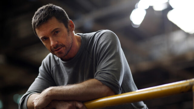 Man Leaning on Railing Desktop Wallpaper