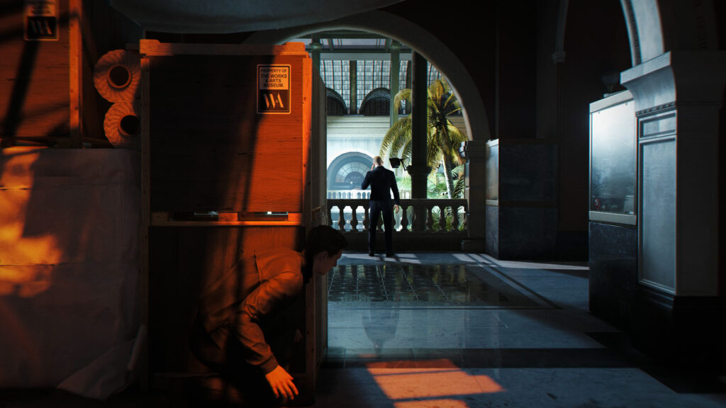 Hitman Agent 47 Lurking Behind Crates Desktop Wallpaper
