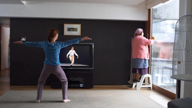 Woman Practicing Tai Chi While Housekeeper Cleans Desktop Wallpaper