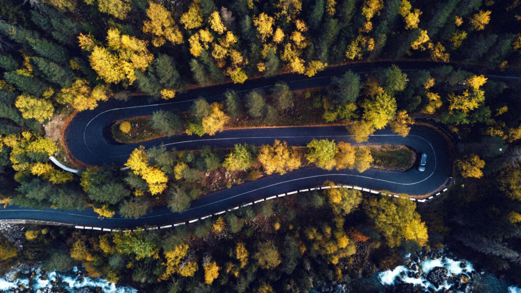 Winding Mountain Road Through Autumn Forest Desktop Wallpaper