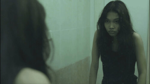Pensive Young Woman Staring Into Mirror Desktop Wallpaper