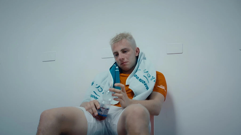 Tired Athlete Resting with Water Bottle Desktop Wallpaper