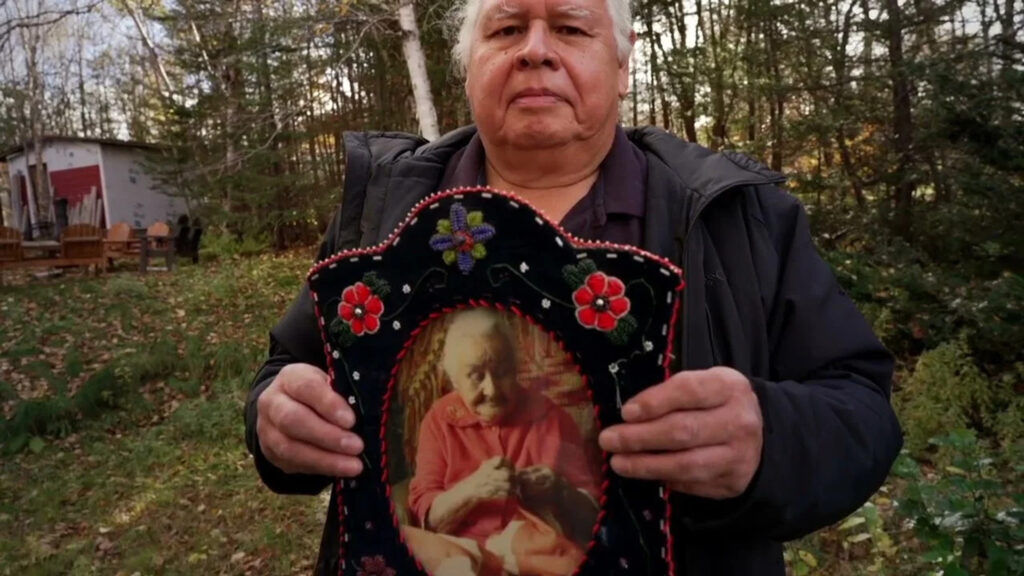 An Elder Holds a Beaded Heirloom Portrait Desktop Wallpaper