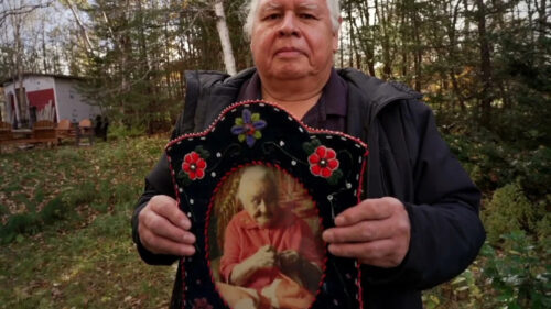 An Elder Holds a Beaded Heirloom Portrait Desktop Wallpaper
