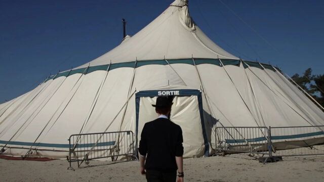 Person Standing Before a Circus Tent Desktop Wallpaper