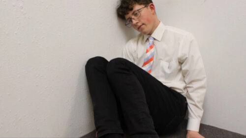 Young Man Sitting in Corner Desktop Wallpaper