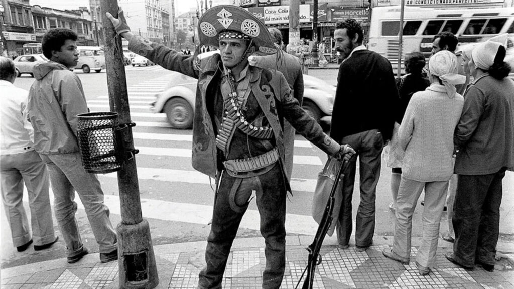 A Cangaceiro Standing in a Busy City Street Desktop Wallpaper