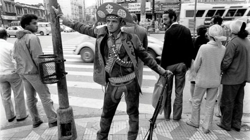 A Cangaceiro Standing in a Busy City Street Desktop Wallpaper