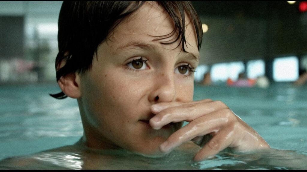 Portrait of a Young Boy Swimming in a Pool Desktop Wallpaper